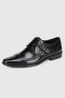 Black leather dress shoe with brogue details on a white background, Obroi
