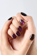 Hand with dark nail polish on a light background, Obroi