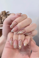 Close-up of hands with decorative nail art on a neutral background, Obroi