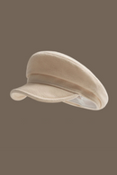 Beige cap on a brown background, Obroi
