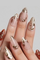 Nails with gold decorative designs on a neutral background, Obroi