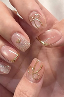 Nails with gold bow design on a light background, Obroi