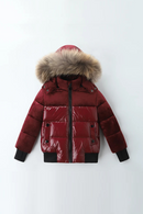 A glossy dark red puffer jacket with a large brown faux-fur trimmed hood, black ribbed cuffs and hem, and a black front zipper, shown against a plain white background, Obroi