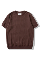 A short-sleeve crewneck sweatshirt in a dark brown color, laid flat on a white background with a soft shadow, Obroi