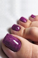 Close-up of a hand with purple glittery nail polish on a white background, Obroi