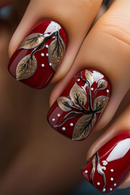 Close-up of red nails with gold leaf and white dot designs, Obroi