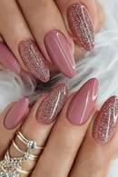 Close-up of hands with pink and glittery nails on a light background, Obroi