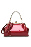 Red handbag with gold accents on a white background, Obroi