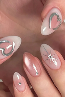 Nails with decorative designs and rhinestones on a neutral background, Obroi