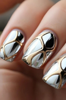 Close-up of nails with metallic gold and silver design, Obroi