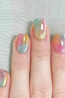 Nails with a gradient design in pink, green, and gold on a light background, Obroi