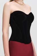 Black strapless top worn by a person on a plain background, Obroi