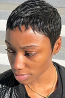 Woman with a short black hairstyle wearing a gold necklace against a striped background, Obroi